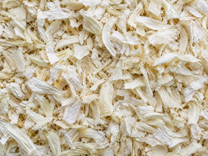 Dehydrated white onion flakes filling the frame